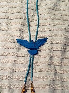 Eagle bolo with turquoise cord and mustard color tassels